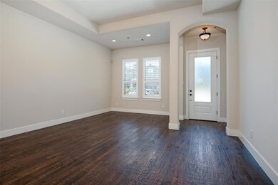 Spacious living room with dining area, designer lighting, and ceiling fan.