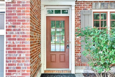 Property entrance featuring brick siding