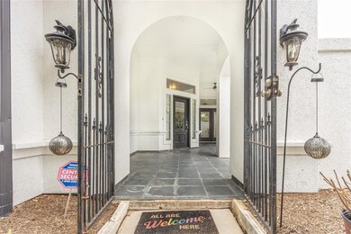 Wrought iron entrance into covered patio that leads to the front door.
