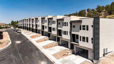 View of property with concrete driveway, a garage, and a residential view