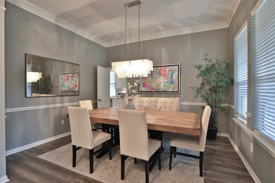 The dining room boasts a beautiful chandelier and has quick access to the kitchen for ease of entertaining.