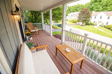 Beautiful covered front porch with maintenance free Tree!