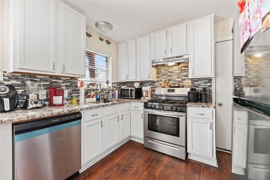 Kitchen featuring backsplash, dark hardwood / wood