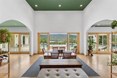 Dining space featuring arched walkways, baseboard