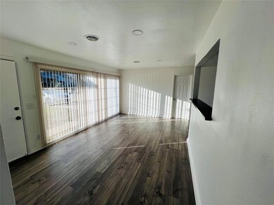 Unfurnished room with dark hardwood / wood-style f