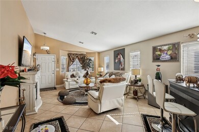 Tiled living room featuring vaulted ceiling