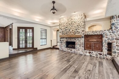 Living room with custom stone fireplace.