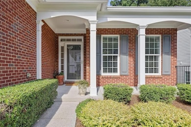 Property entrance with brick siding and a porch