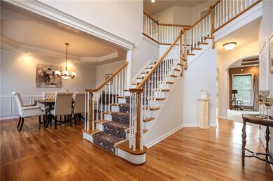 A wonderfully spacious 2-story entry foyer warmed 