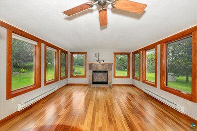 Unfurnished living room featuring a baseboard heat