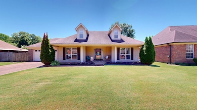 View of front facade featuring driveway, an attached garage, a porch, and roof with shingles