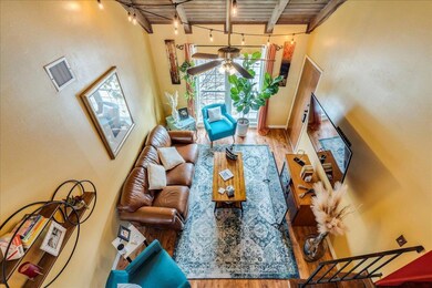 Living area with wood finished floors, ceiling fa