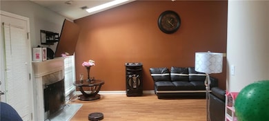 Living room with lofted ceiling, wood-type floorin