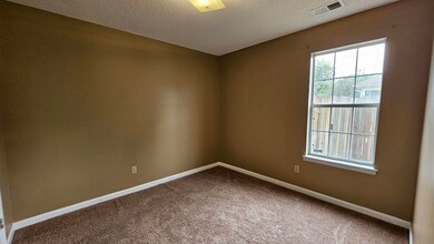 Spare room featuring a textured ceiling and carpet