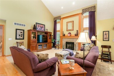 The foyer leads to the two story great room with a fireplace.
