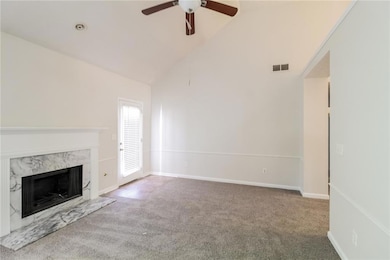 Unfurnished living room with ceiling fan, a firepl