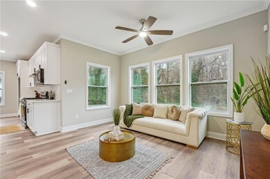 Living area with crown molding, plenty of natural 