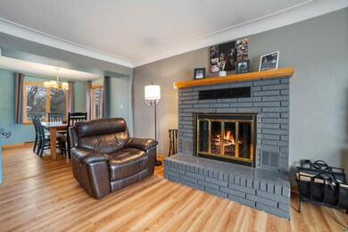 Living room with a fireplace, wood-type flooring, 