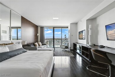 Bedroom featuring a wall of windows, multiple windows, dark wood-style flooring, access to exterior, and built in study area