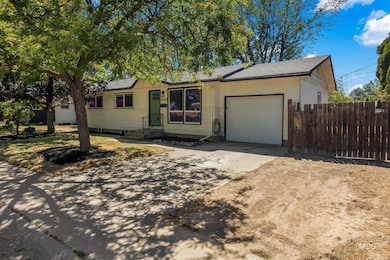 Ranch-style house with a garage, driveway, and roof with shingles