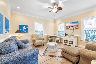 Living room featuring ceiling fan, light tile patt