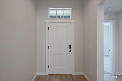 Entryway featuring baseboards and wood finished floors