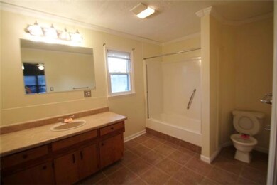 Master bath with tiled flooring and additional large closet.