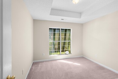 Unfurnished room with a textured ceiling and carpe