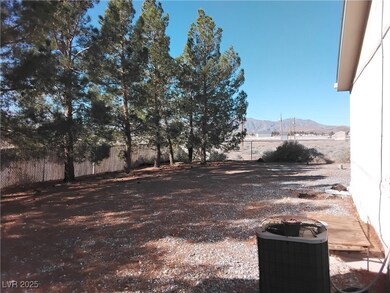 View of yard with fence, a mountain view, and cool
