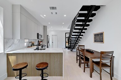Kitchen featuring visible vents, a peninsula, a s