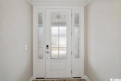 Doorway featuring baseboards and wood finished flo
