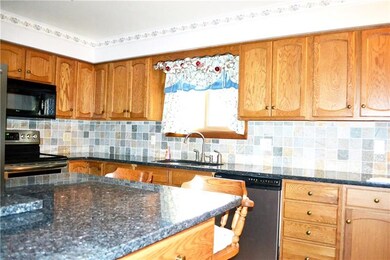 Kitchen features granite countertops and oak cabin