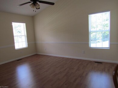 Living room looking from near opening to kitchen and entrance to hallway.  Front door is to the left.