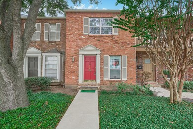 Charming two-story brick townhouse with a striking