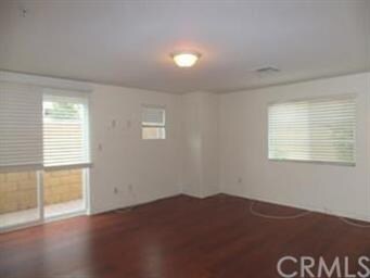 Downstairs bedroom with slider to side yard