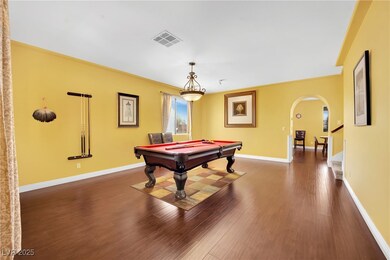 Rec room with dark wood-style floors, billiards, visible vents, baseboards, and arched walkways