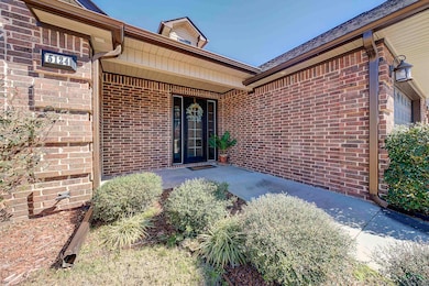 Entrance to property featuring brick siding