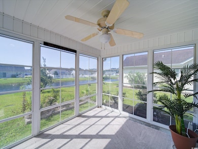 Sunroom featuring a water view, ceiling fan, and plenty of natural light