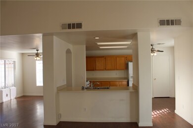 Open floor plan with view into kitchen and dining
