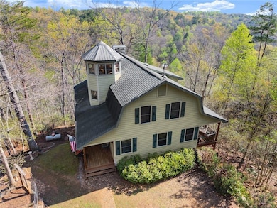 View of front of property with a forest view and r