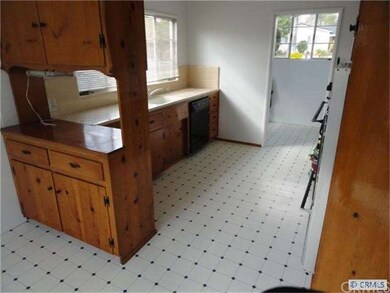 Kitchen is adjacent to laundry room with pantry.