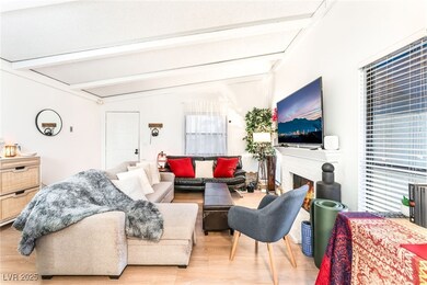 Living area with wood finished floors and a brick fireplace