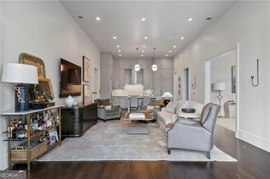 Living area with wood finished floors and recessed lighting