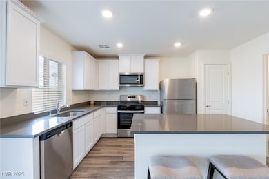 Kitchen with white cabinets, stainless steel appli