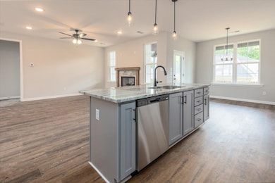 Kitchen with a sink, gray cabinets, dark wood-type