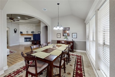 Dining area featuring arched walkways, a chandelie