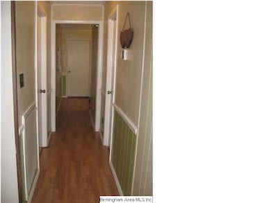 Laminate hardwoods continue from the living room d