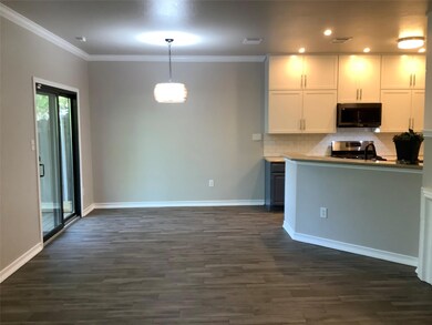 Kitchen with dark wood finished floors, backsplas