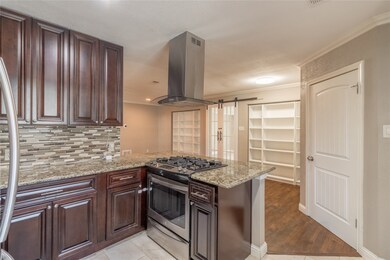 Beautifully updated kitchen with granite countertops, stainless steel appliances, and much cabinetry for plenty of storage.
