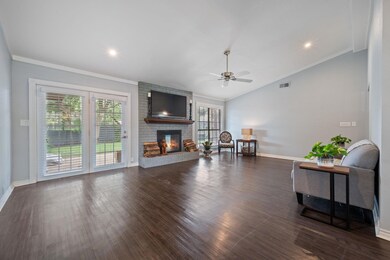 Living room with a brick fireplace, vaulted ceili